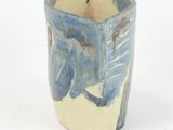 a blue and white cup with a bird design on it