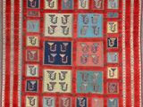 a red and blue rug with many different designs on it