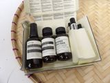 bottles of skin care products sitting in a basket on top of a table