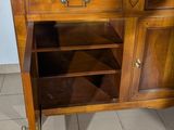 a small wooden cabinet with a drawer underneath it