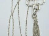 an image of a silver necklace with a chain and a tassel
