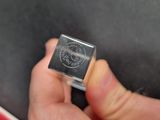 a person holding a small metal object in their hand