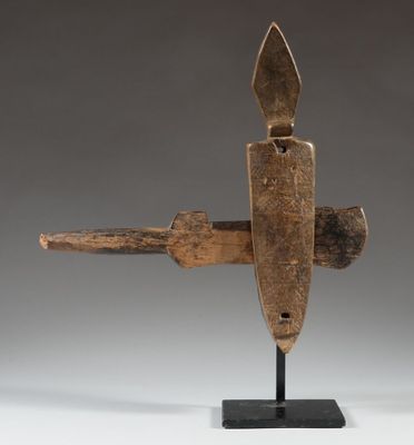 a wooden sculpture of a knife on a black stand