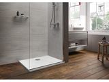 a close up of a walk in shower with a wooden floor