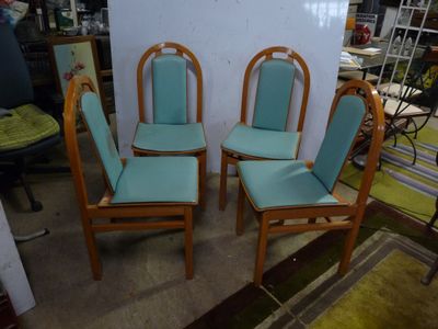 four chairs with blue upholstered seats in a room with a rug