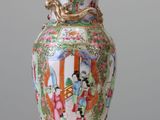 a vase that is sitting on a table with a lid