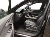 the interior of a car with the door open and the driver ' s seat down