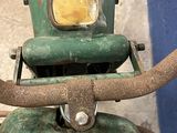 a close up of a green motorcycle with a yellow light on it ' s head