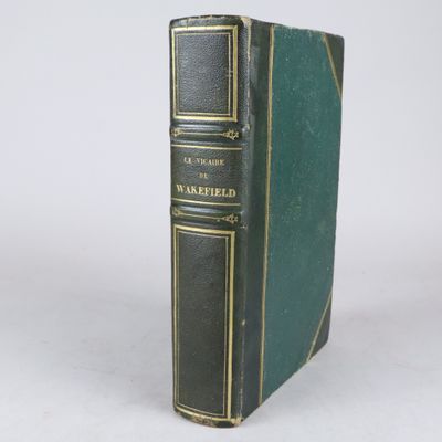 un vieux livre à la couverture verte posé sur une table