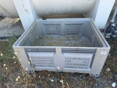 a plastic crate that is sitting on the ground