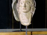 a statue of a woman ' s head on display in a window