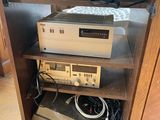a shelf that has a bunch of electronics on top of it