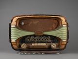 an old radio sitting on top of a wooden stand