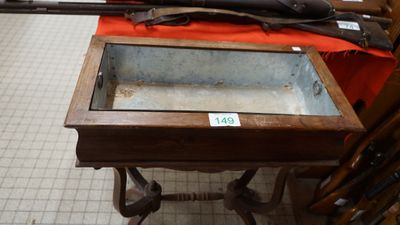a table with a glass top and a gun on top of it