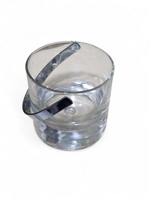 a glass of water with a spoon sticking out of it