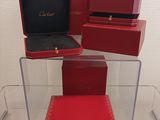three red boxes are stacked on top of each other in a display case