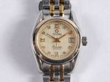 a silver and gold wrist watch on a white surface