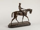 bronze statue of a man riding a horse on a marble base