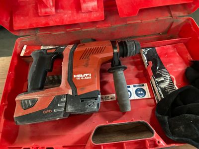 a red tool box with a hammer and other tools in it