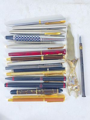 many pens and a pair of scissors on the table