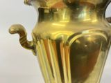 a gold vase that is sitting on a table