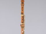 a wooden clarinet with a black top and gold trim
