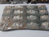 a piece of metal that has a lot of carvings on it