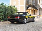 a black sports car parked in front of a house