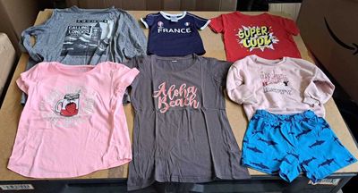 a lot of t - shirts that are sitting on a box