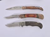 five different types of knives on a white surface