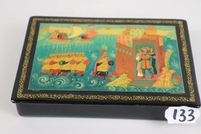 a small box with a painting on it on a table