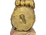 a gold clock with birds on top of it on a marble base