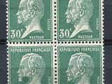 four green stamps with a portrait of a man and a woman