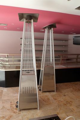 two tall metal heaters in the middle of a room