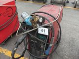 a red barrel with a hose attached to it next to other equipment