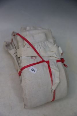 a stack of white cloth wrapped in red ribbon