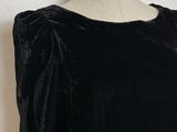 the back of a black top with a blue and green logo on it