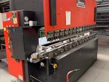 a red and black machine in a warehouse with a red floor