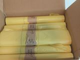 boxes of yellow plastic material are stacked on top of each other