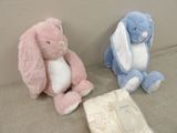 two stuffed animals sitting next to each other on a couch