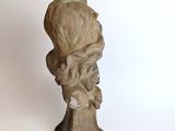 statue of a man with long hair and a beard on a white background