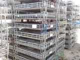 a large pile of scaffolding in the middle of a field