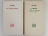 two books are sitting on a white surface one is open and the other is closed