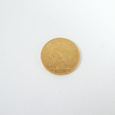 a close up of a gold coin on a white surface