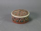 an ornately decorated box sitting on top of a table