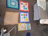 several pieces of art are laid out on the floor in a room