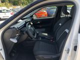 the interior of a white car with black seats and a steering wheel