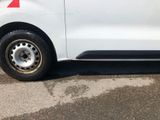 a white van with a red stripe parked in a parking lot
