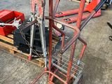 an image of a red hand truck in a garage