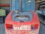 a red tractor that is parked in a garage